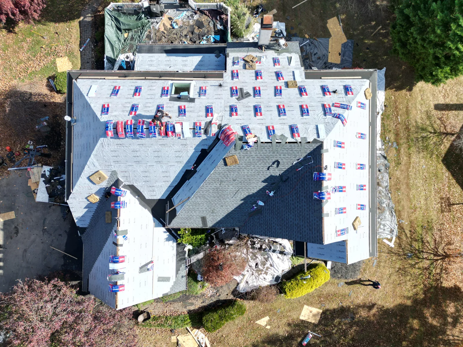 Underlayment installed across a roof mid-replacement