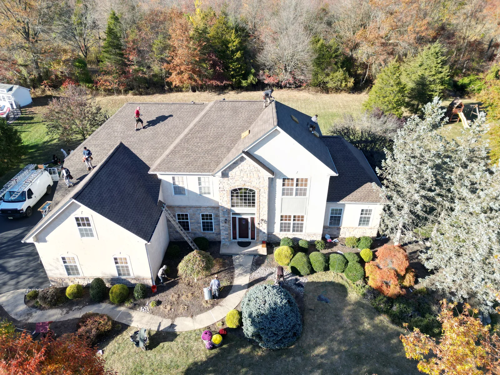 Finished charcoal roof on a cream-sided colonial home